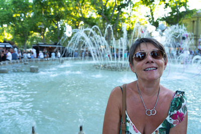 Portrait of a smiling young woman in swimming pool