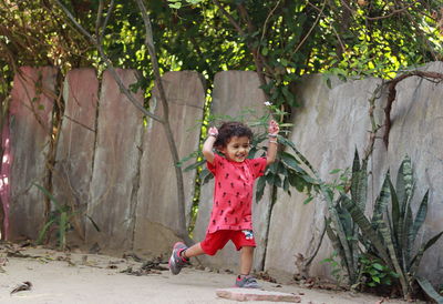 Portrait of a girl standing against plants