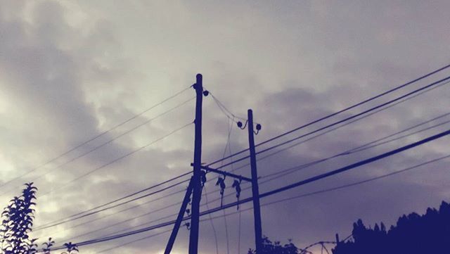 low angle view, sky, connection, power line, cloud - sky, cable, cloudy, electricity, electricity pylon, cloud, built structure, power supply, architecture, bridge - man made structure, outdoors, day, no people, blue, power cable, engineering