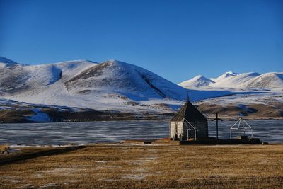 Scenic view of snowcapped mountains against clear blue sky