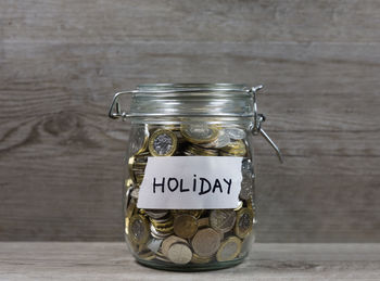 Close-up of coins in jars on table