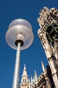 Street lamp in munich with historic city hall in vertical format