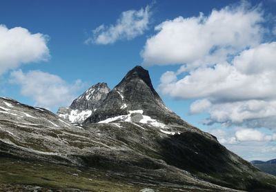 Scenic view of mountains against cloudy sky