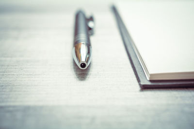 Close-up of pen on table
