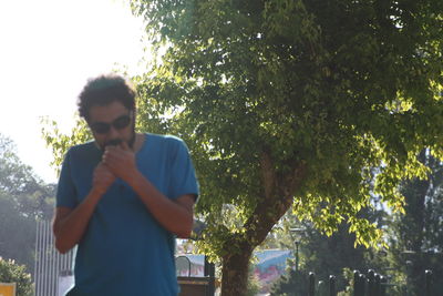 Low angle view of man standing against trees