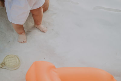 Low section of man standing on white floor