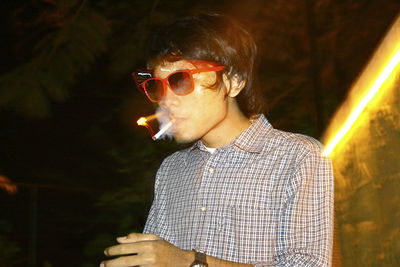 Man smoking cigarette at night