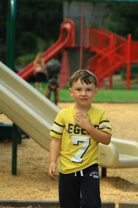 Portrait of boy standing on playground