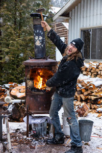 Man standing by fire hydrant in winter