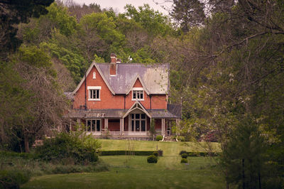 House and trees on lawn of building