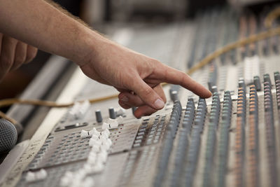 Close-up of hand using sound mixer