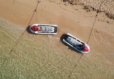 High angle view of speedboats moored at beach