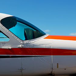 Close-up of airplane against clear blue sky