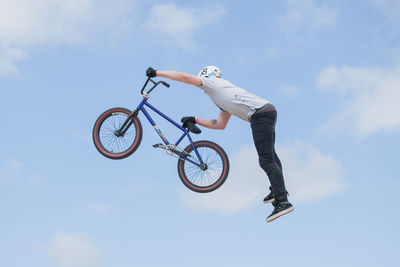 Low angle view of man riding bicycle