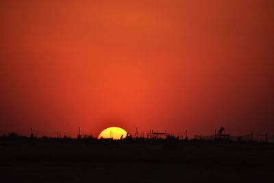 Silhouette of buildings against sky during sunset