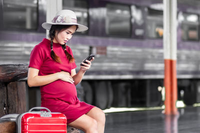 Portrait of young woman using mobile phone