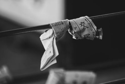 Close-up of human hand holding paper hanging