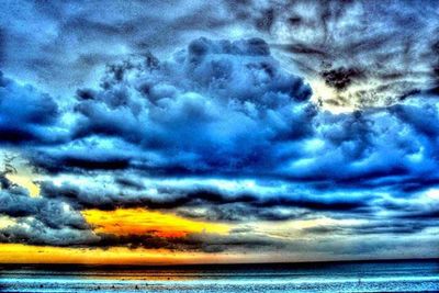 Scenic view of sea against cloudy sky