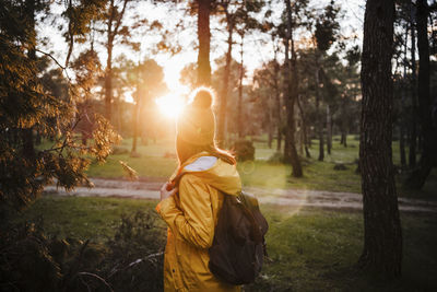 Rear view of people on field in forest