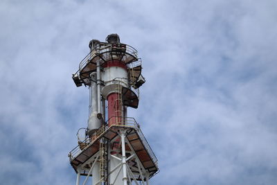 Low angle view of communications tower against sky