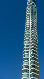 Low angle view of modern building against clear blue sky