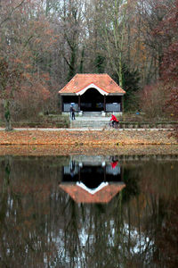 Built structure in lake against trees in forest