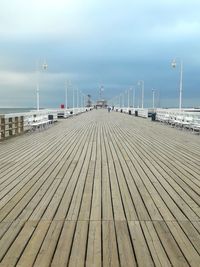 Surface level of pier on sea against sky