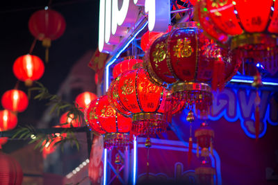 Close-up of illuminated lanterns hanging at night