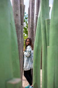 Woman standing against tree