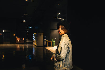 Side view of woman looking away at night