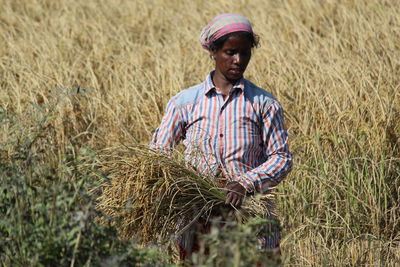 Female farmer standing on field