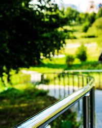Close-up of railing by plants in park