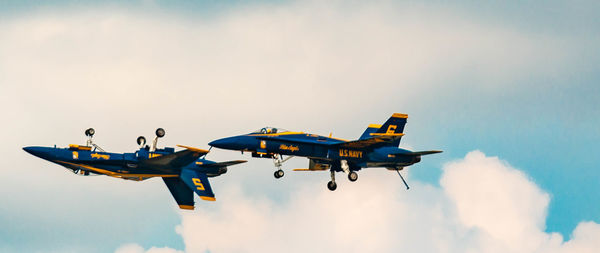 Low angle view of airplane flying against sky