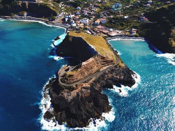 High angle view of rock formation amidst sea