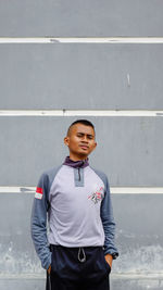 Indonesian man poses stands wearing a t-shirt with the indonesian flag