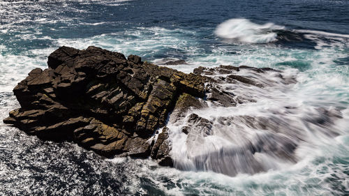 Waves splashing on rocks at shore