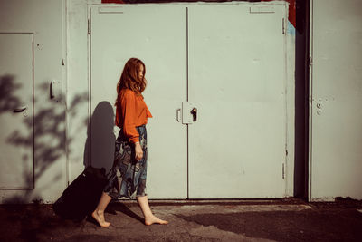 Woman standing by door