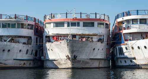 Boats moored in sea against clear sky