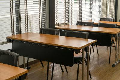 Close-up of empty chairs on table