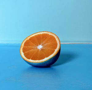 Close-up of lemon slice against blue background