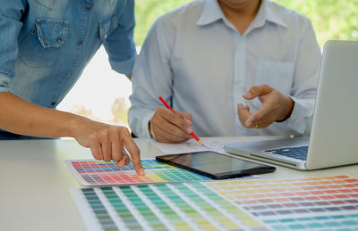 Close-up of people working at home