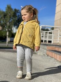 Full length of cute girl standing outdoors