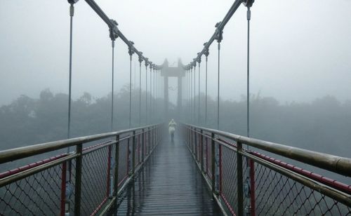 View of suspension bridge in foggy weather