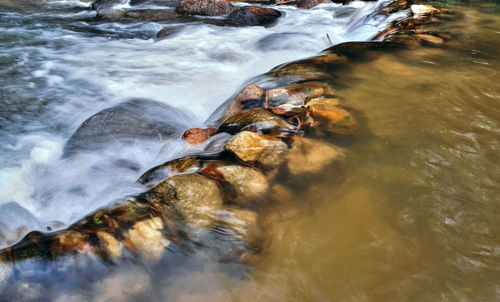 Scenic view of waterfall in sea