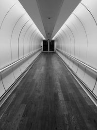 Empty road leading towards building