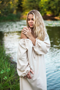 Woman standing by lake