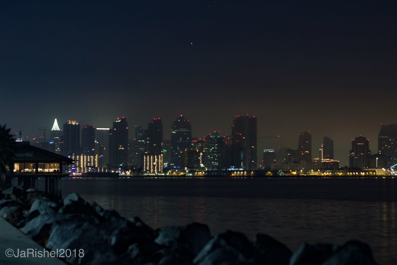 ILLUMINATED CITY AT WATERFRONT