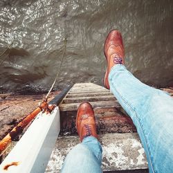 Low section of woman standing in water