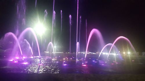 Firework display against sky at night