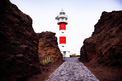 Lighthouse on the ocean shore on a cold and windy day, in the mountains of tenerife, punta de teno